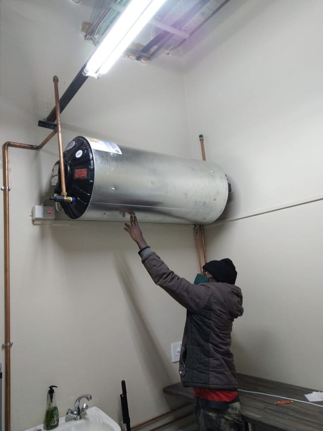 Professional plumber mounting pipelines